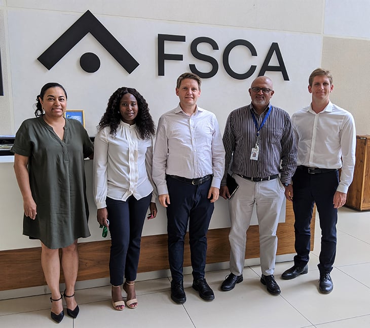 Five people standing in front of a FSCA- logo